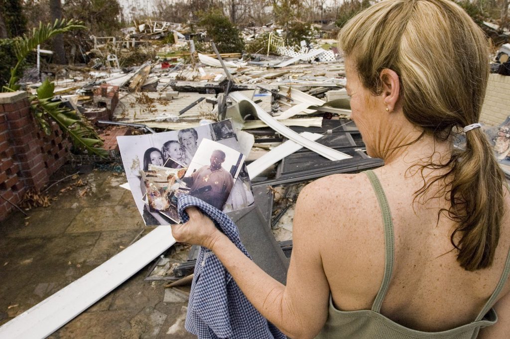 Aftermath of Hurricane Katrina. In Waveland, MS, nearly a quarter mile in from the ocean, a woman who asked not to be shown or identified, picks through ruins of her home destroyed by 29 foot high storm surge. Essentially the only thing deemed with saving were a few family photographs that somehow survived the torrent.